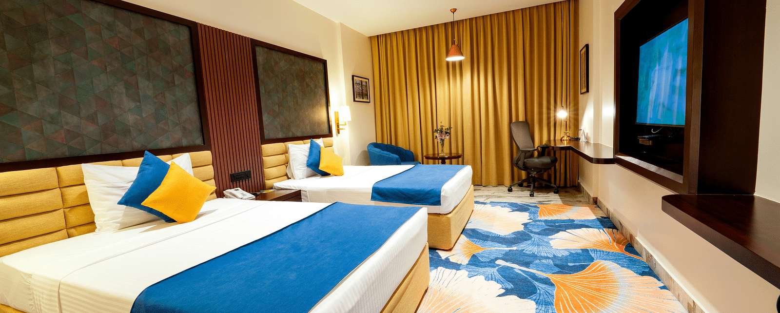 Room at Sitara Luxury Hotel in Hyderabad near Ramoji Film City with twin beds and a television