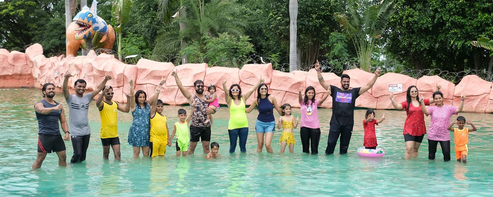 Group of friends posing joyfully in a shallow water pool at a theme park | Diamond Parks, Pune 