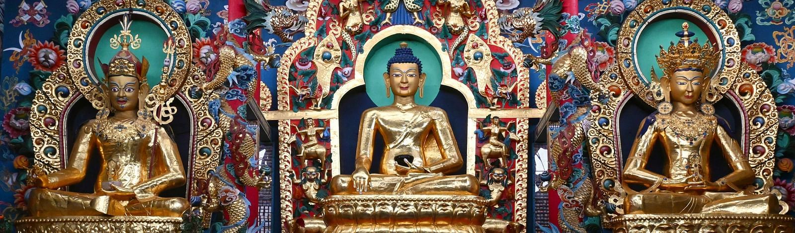 Ornate display of Buddhist-style idols near Coorg Jungle Camp Backwater Resort, highlighting cultural richness in Kushalnagar.