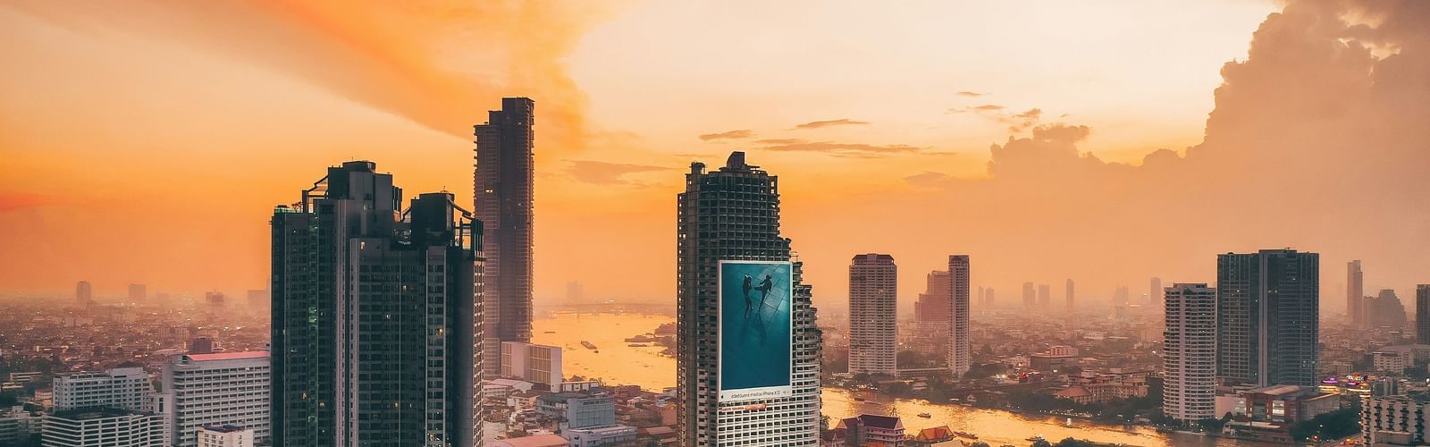 Bangkok City skyline with sunset over the River of Kings in the Silom area.