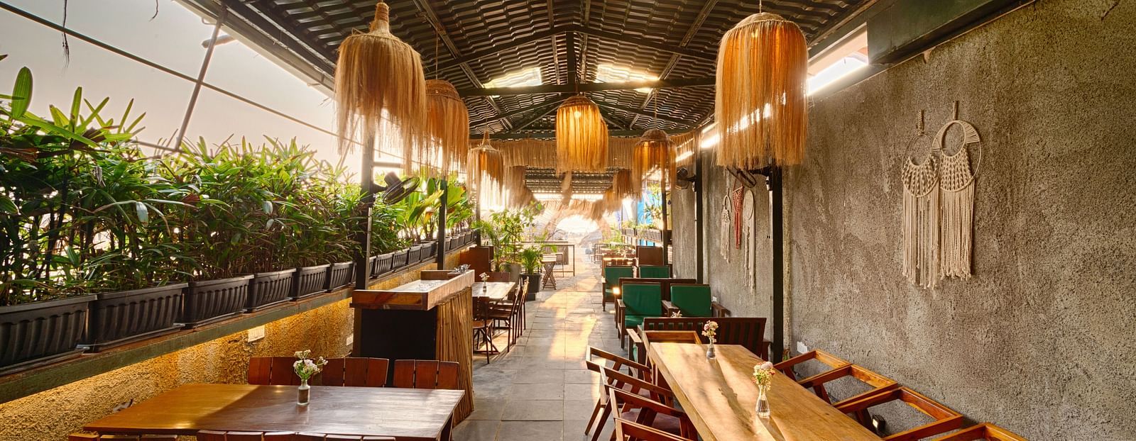 Indoor seating with wooden furniture and warm lighting at Royale Amata by the Beach Restaurant