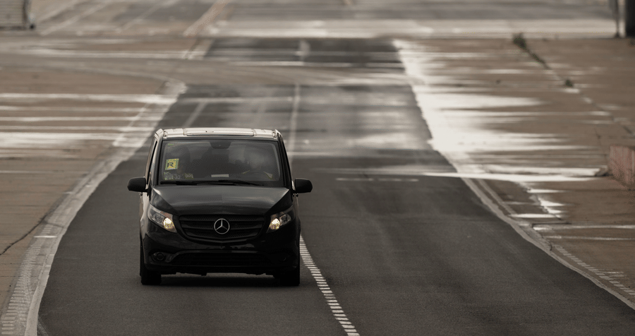 A vehicle on an open road representing airport transfer and cab service available at Bhavanis Vista By Icon Hosur.