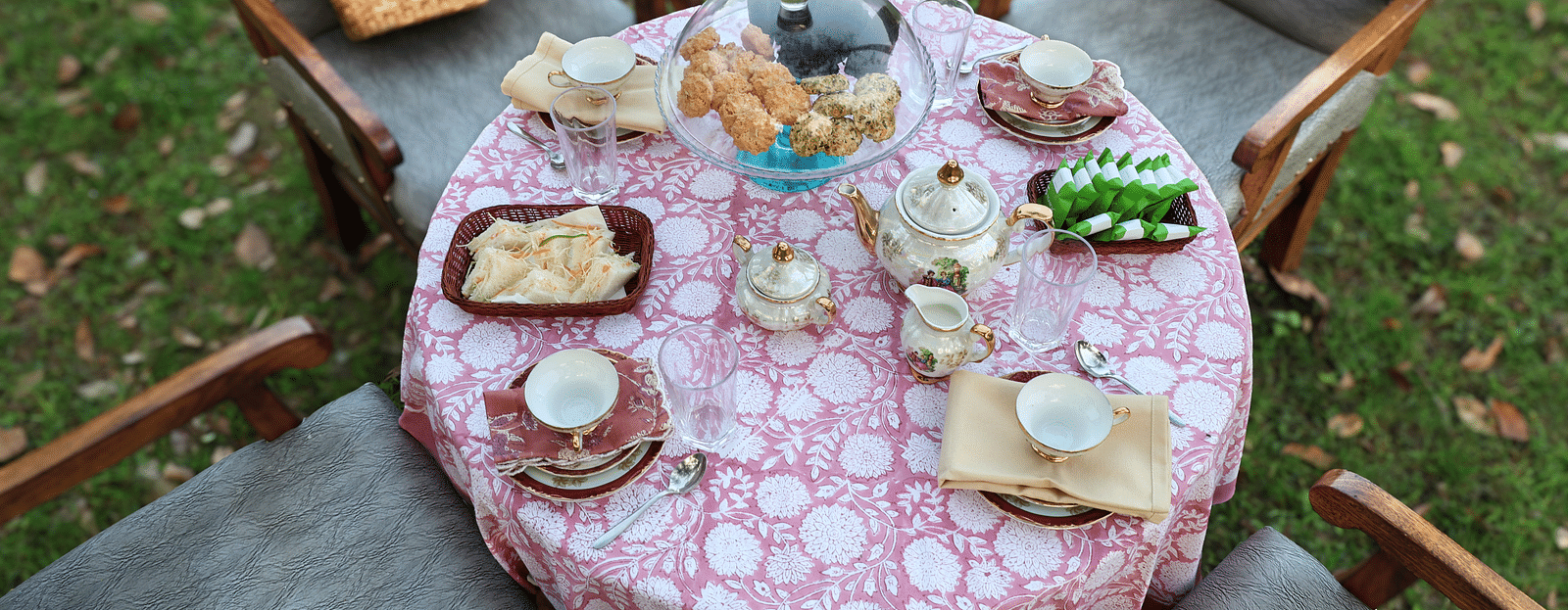 A top-angle view of the breakfast table surrounded by chairs placed in an open-air setting during the day at The Sylvan Retreat, Dehradun.