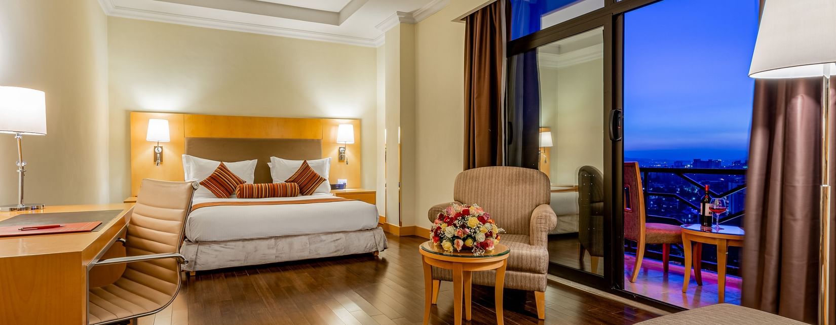 An overview of a room with a king bed, chairs and table inside one of the rooms - Ramada by Wyndham Addis, Addis Ababa