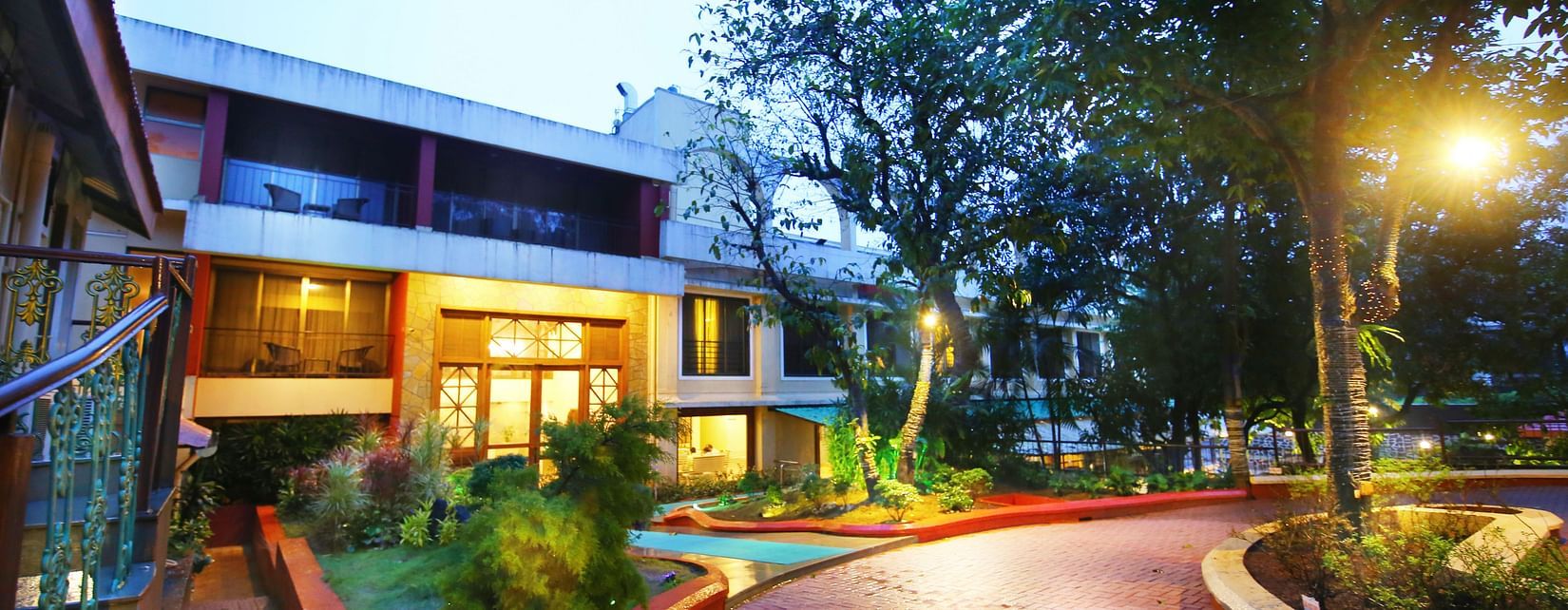 the outside lawn area at the resort during evening time - Zara's Resort