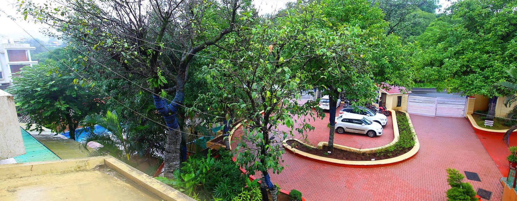 a panoramic view of the swimming pool and the lawn of the property- Zara's Resort
