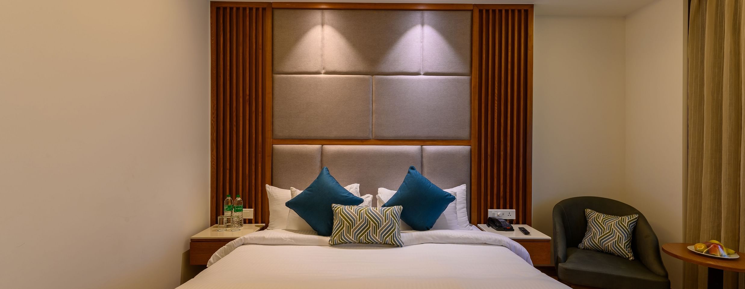 The interiors of the Classic Rooms in Pushkar featuring a bed, a sofa chair and exquisite furnishings at our resort 135