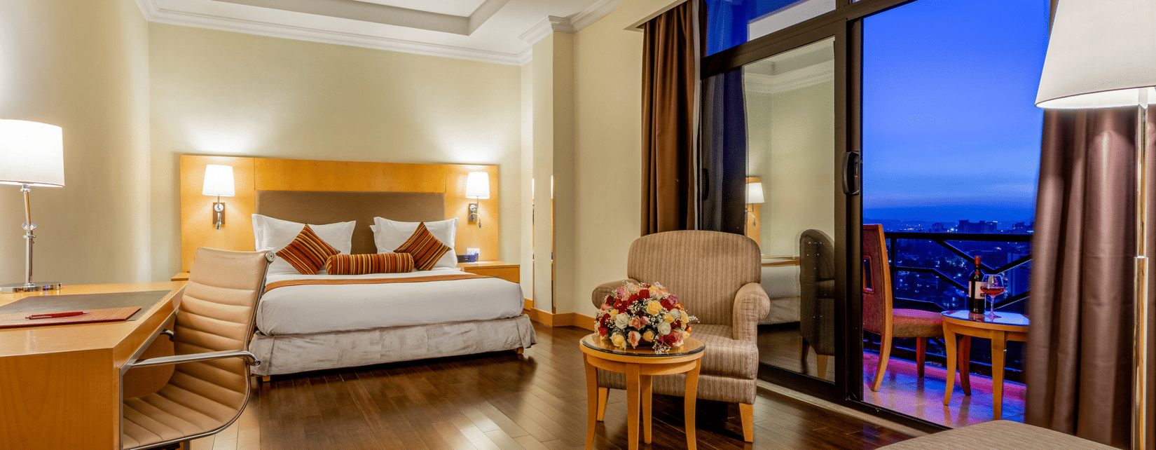 An overview of a room with a king bed, chairs and table inside one of the rooms - Ramada by Wyndham Addis, Addis Ababa
