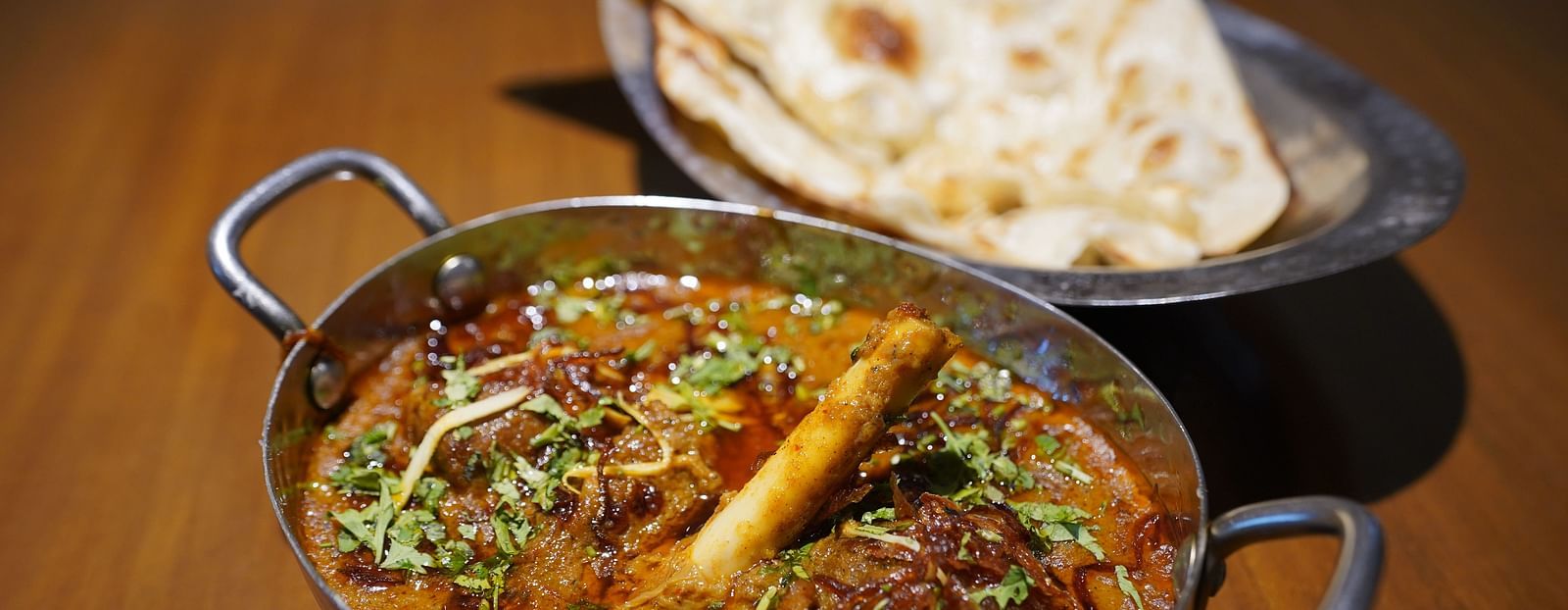 An image of kadhai chicken and naan placed on a table - Argo By Trance, Goa