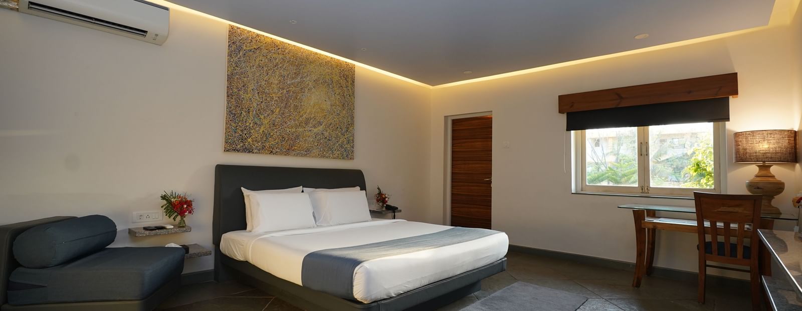A bedroom with a double bed and wooden furnishings - Argo By Trance, Goa