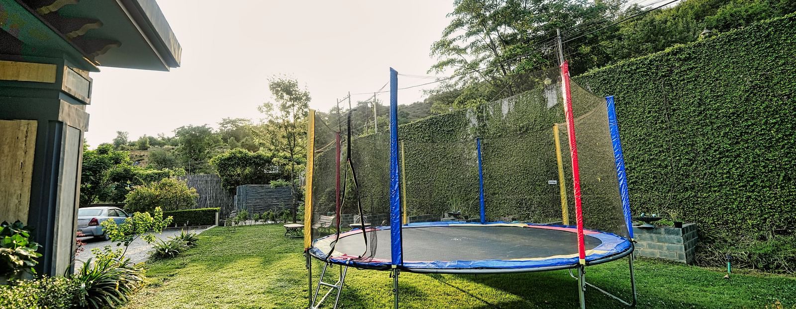 A close-up picture of a trampoline placed in lawn, captured in a day light.