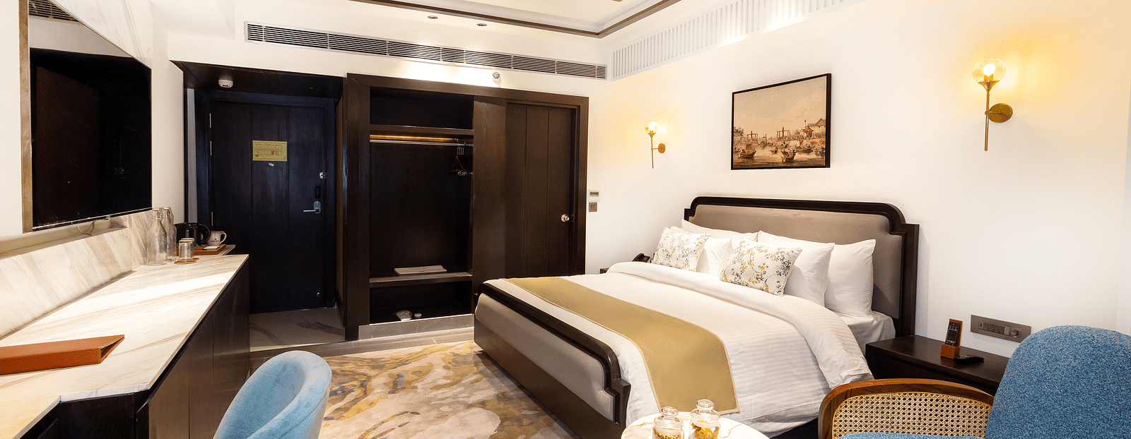Image of a room with a bed and seating area on the side at Auradoon, Dehradun.
