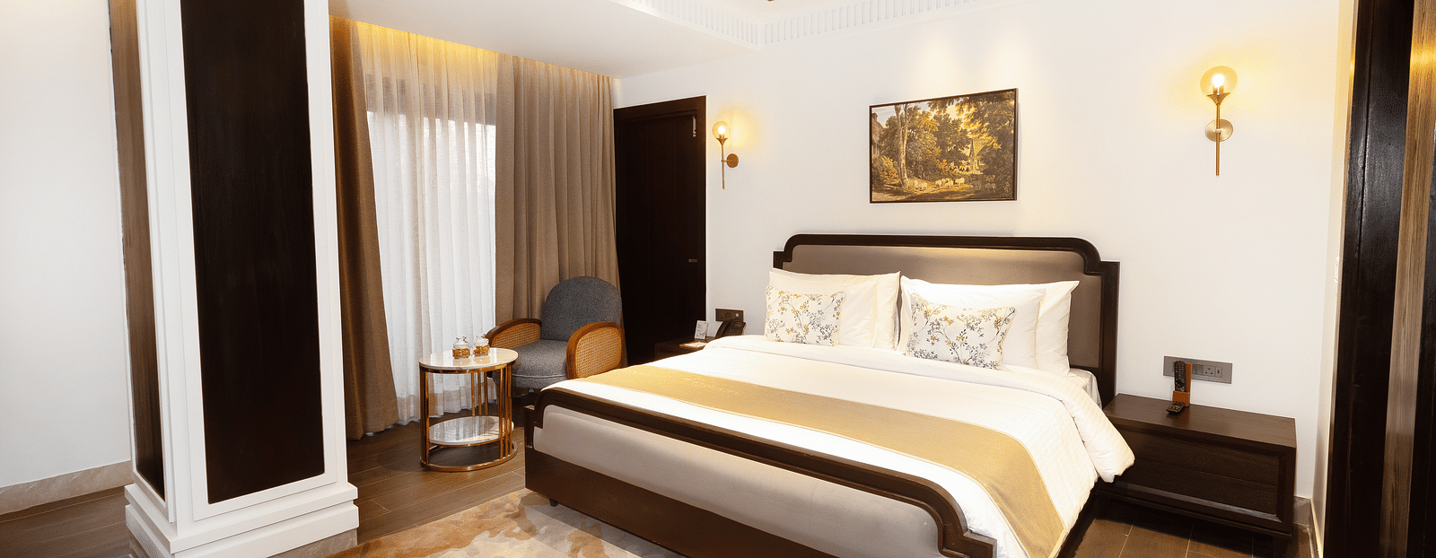 Image of Superior Room with a bed and a photo frame above it at Auradoon, Dehradun.