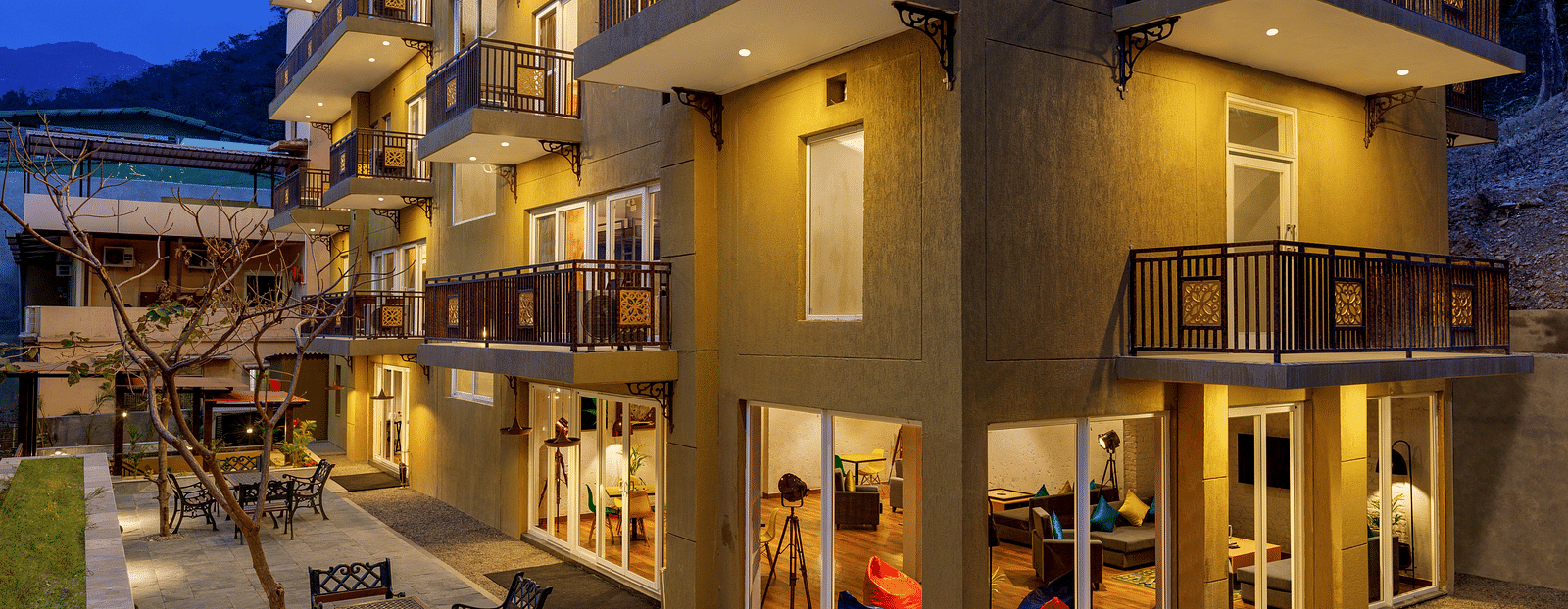 Exterior of the property with dining arrangements on the ground - Bedzzz, Rishikesh