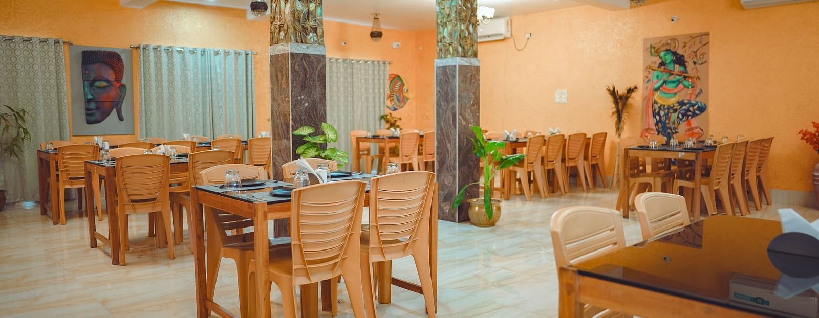 image of a well lit dining area with proper seating arrangements for the guests - Dip Holidays, Birbhum