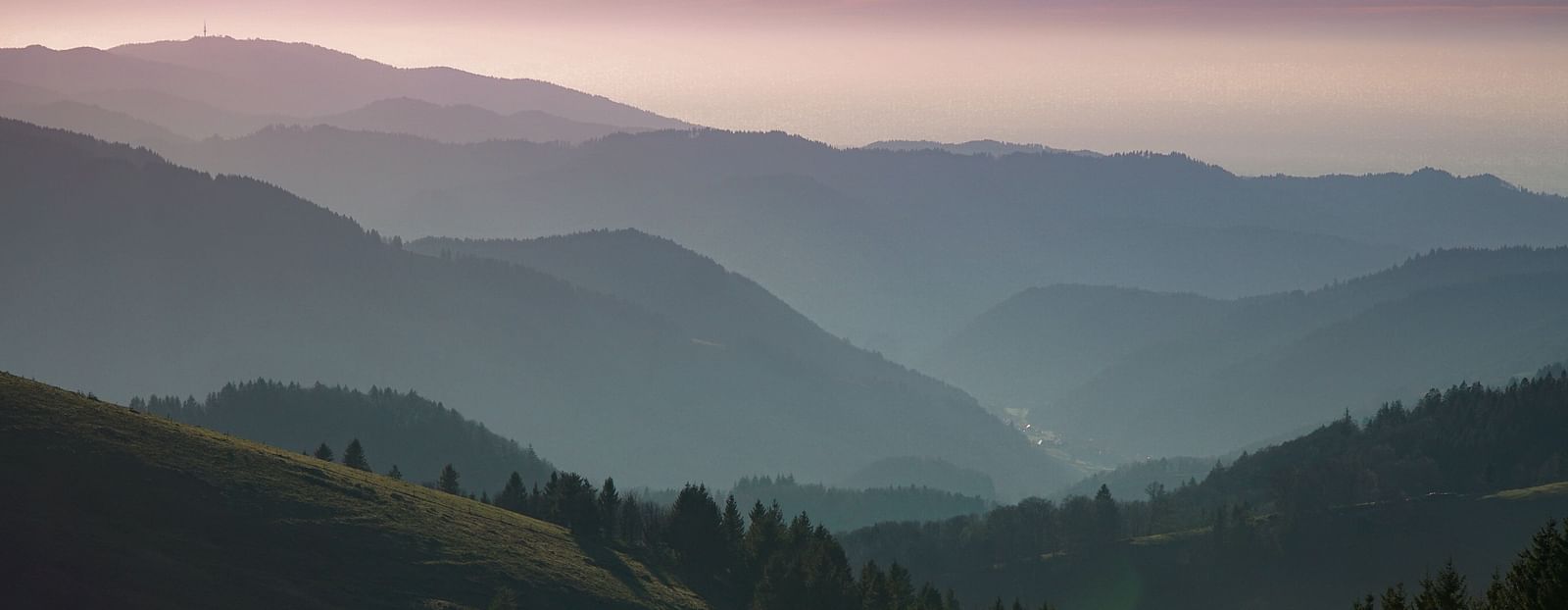 An image of hills covered with clouds and fog