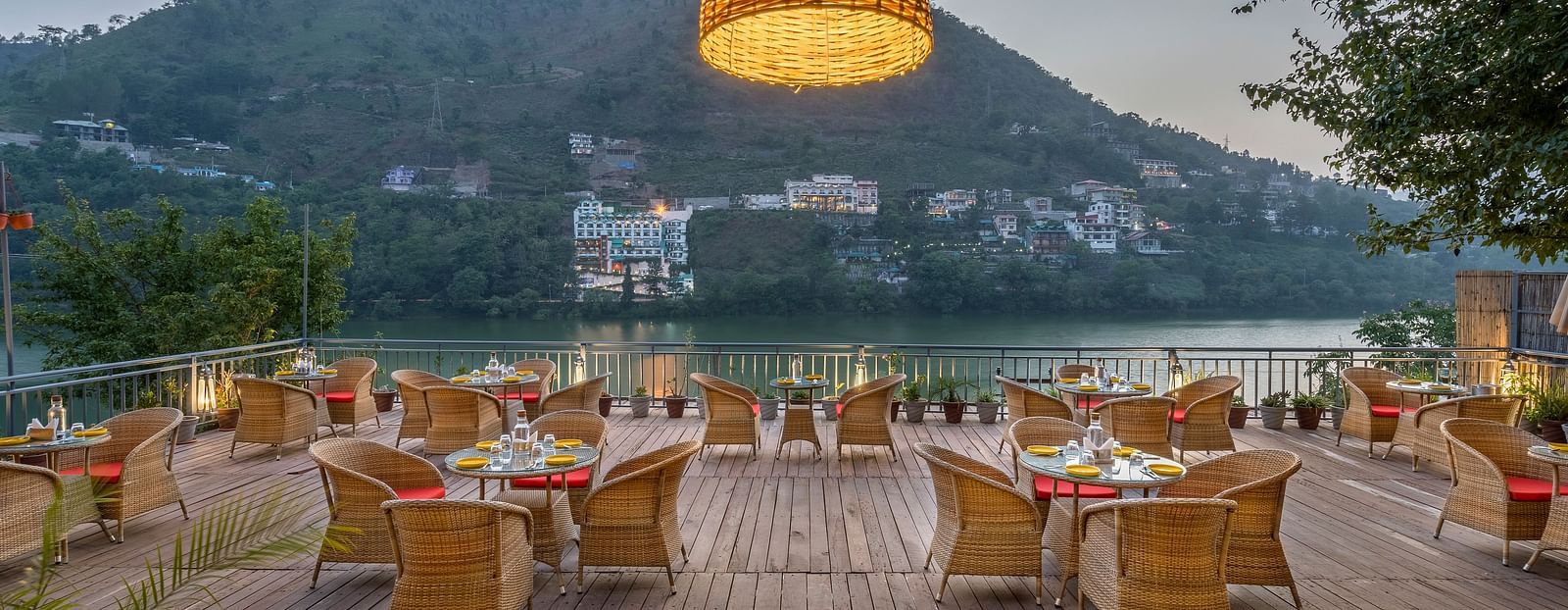 Wide angle shot of L-attitude deck with a beautiful lake and mountain view at Fishermen's Lodge, Bhimtal 