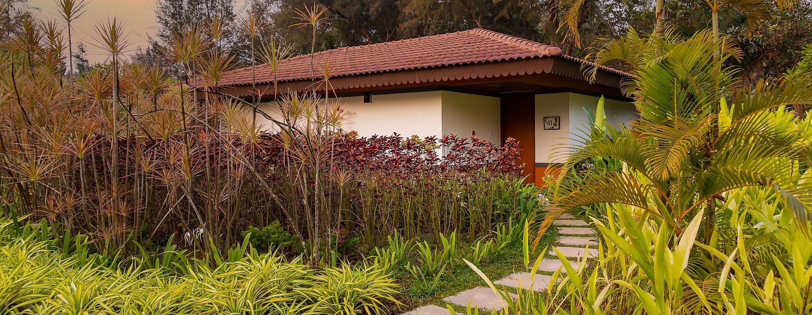 An far out view of the Villa with various trees and plants around it - Gamyam Retreat