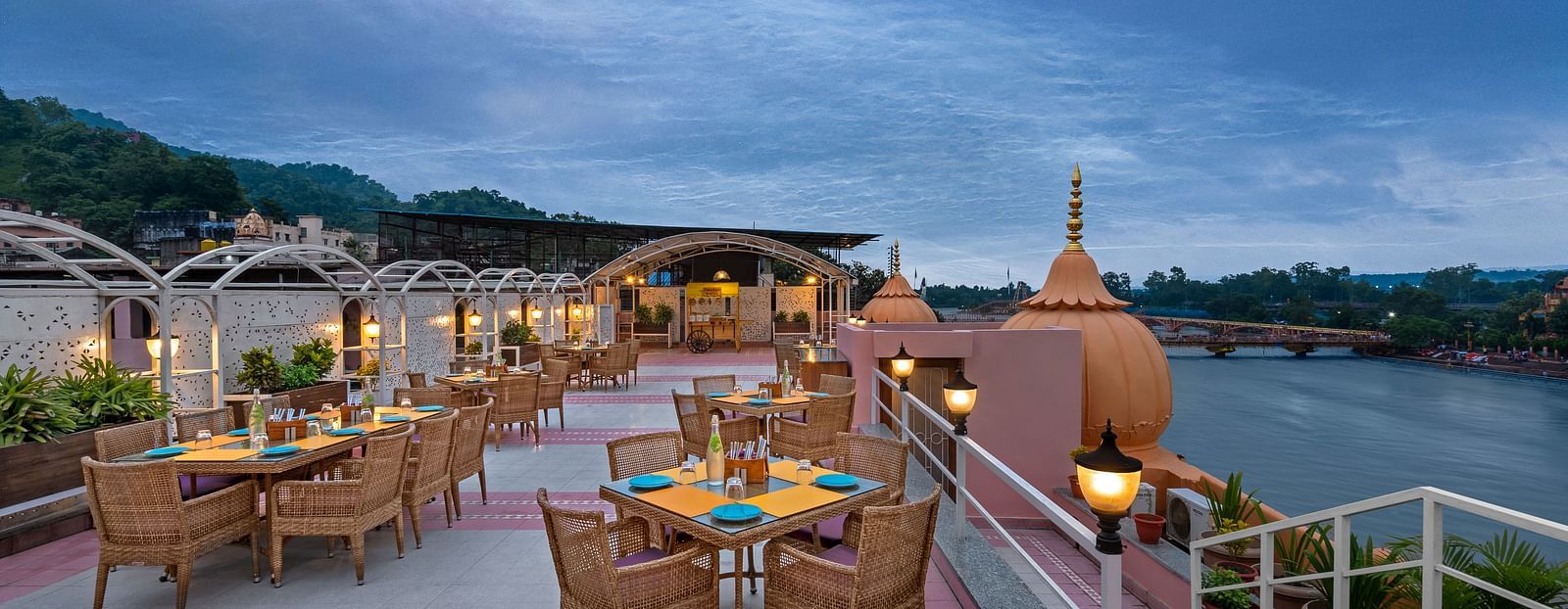 Outdoor seating at The Patio rooftop café overlooking the Ganges river near Har Ki Pauri, Haridwar.
