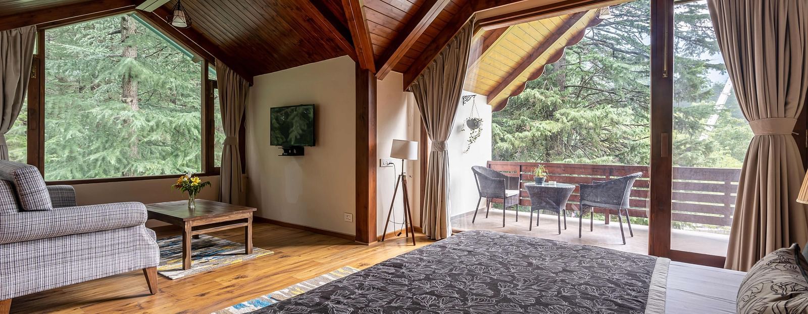 Room featuring a wooden ceiling and a view of lush greenery from the window.