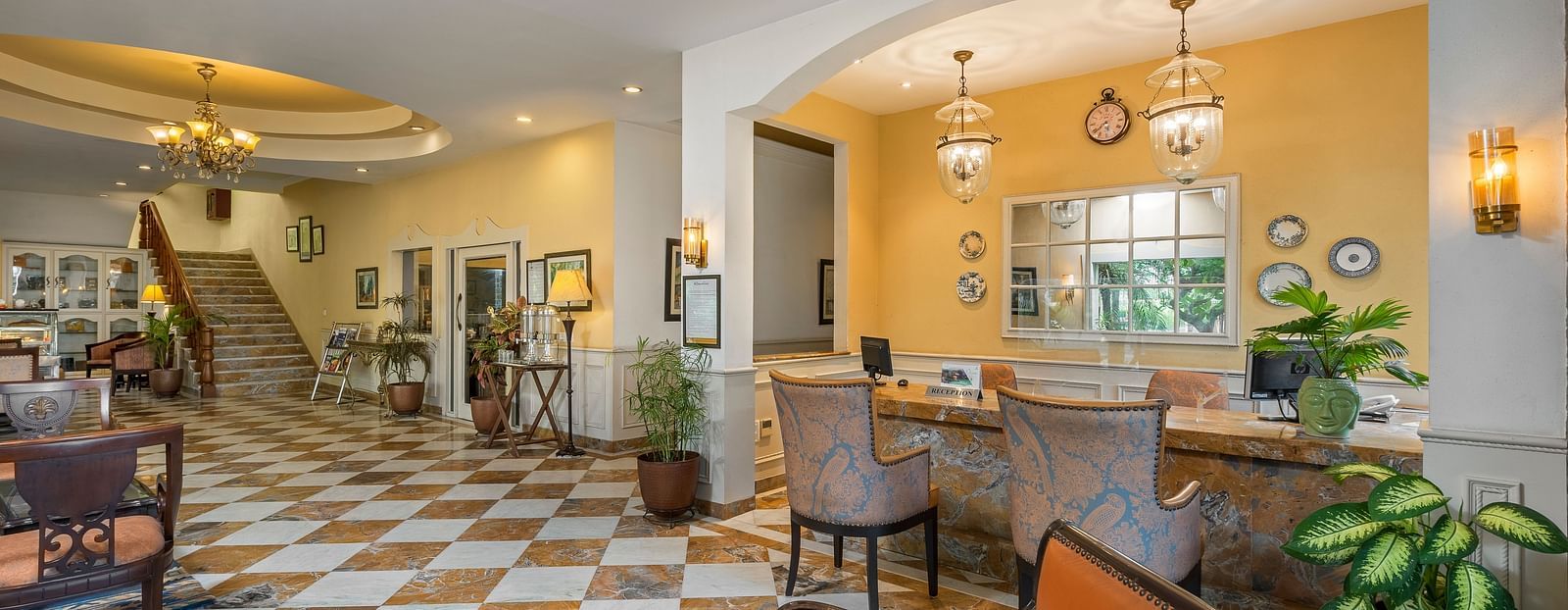 A wide view of the reception of the hotel with chairs and tables in clusters across the room - The Manor, Kashipur