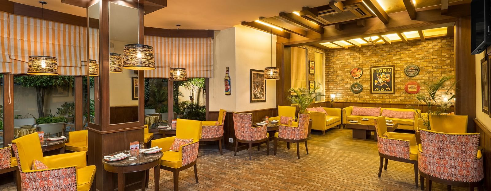 view of a room with clusters of tables and chairs placed close to the walls - The Manor, Kashipur