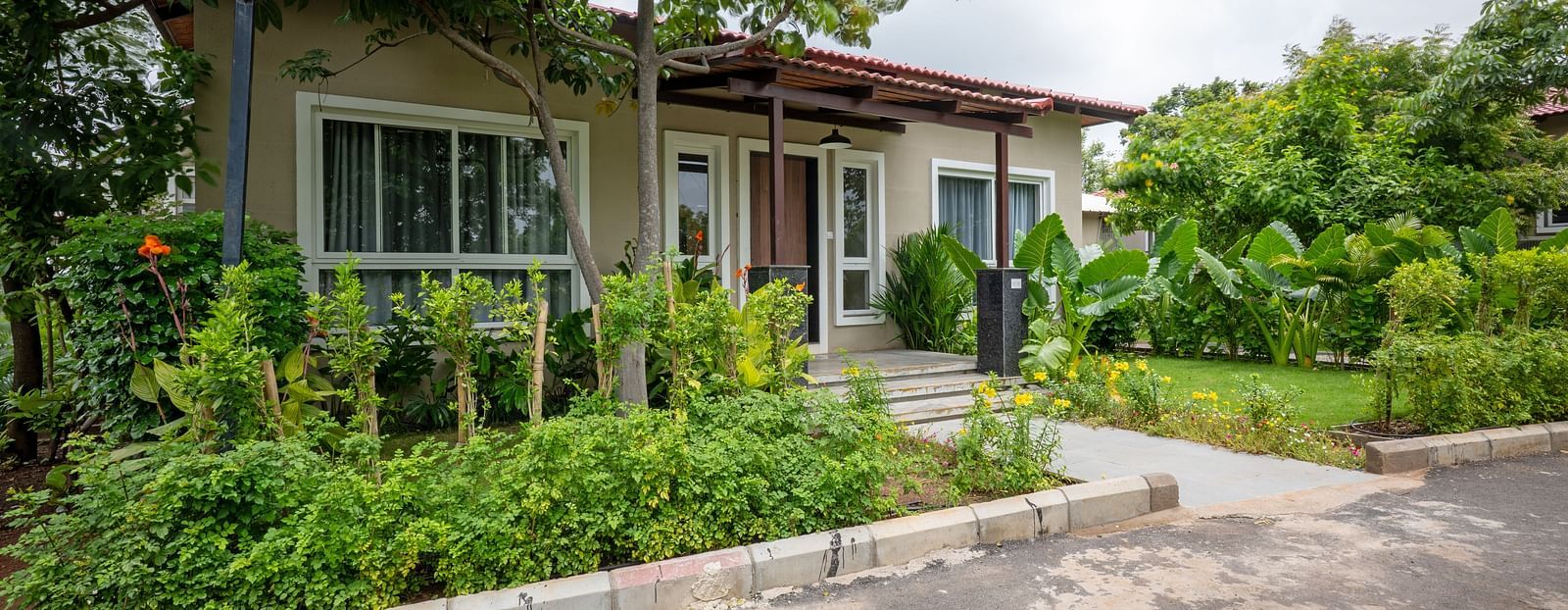 Front view of Ananta Villa – 3-Bedroom Villa at Trance Veechika Resort, Vikarabad, surrounded by a lush green landscape.