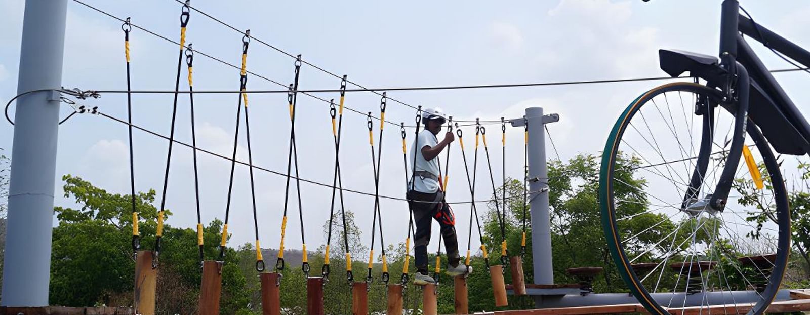 An image of a man crossing the rope obstacle course - Trance Veechika Resort