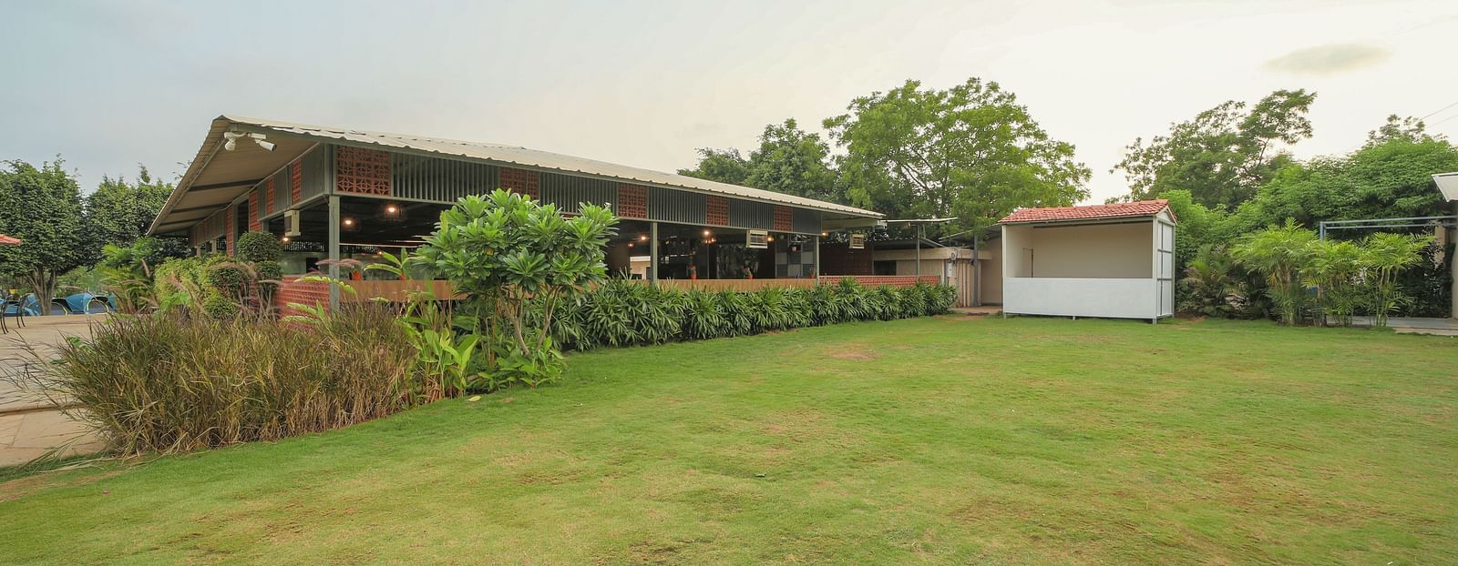 A facade image of a lawn with greenery around - Trance Veechika Resort, Vikarabad