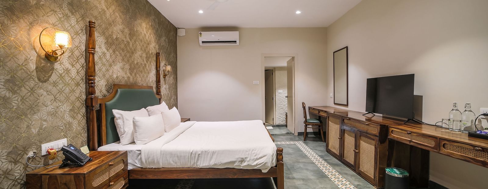 An image of a room with king size bed, TV, bed side table - Trance Veechika Resort, Vikarabad