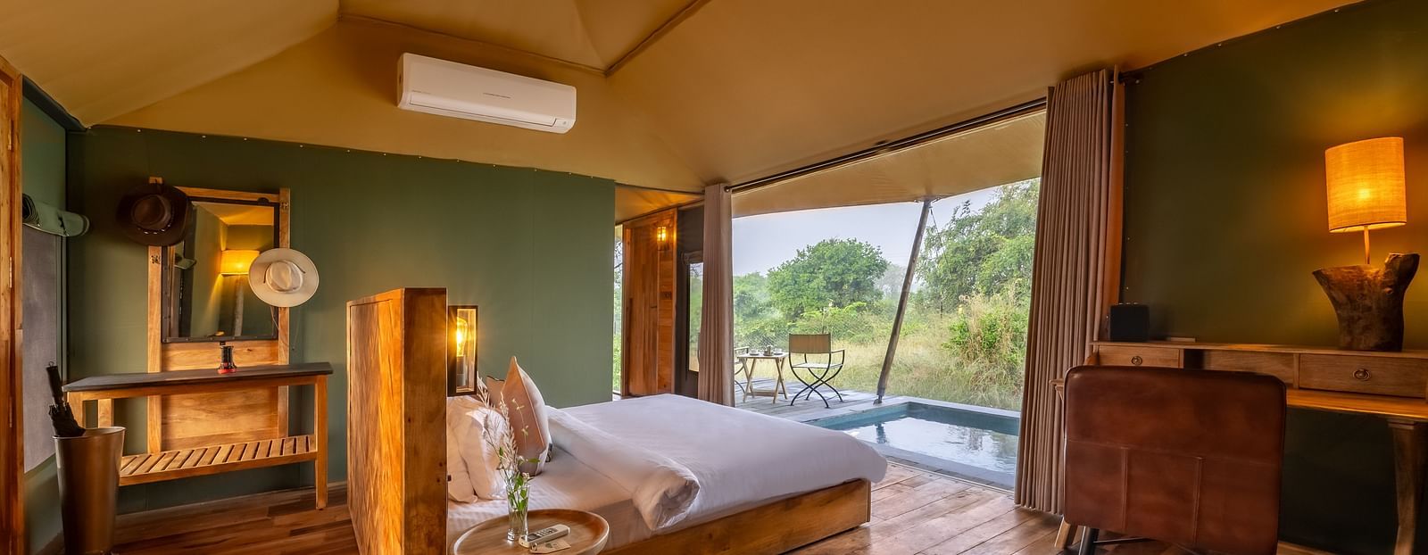 An interior of a room with double bed at Trees N Tigers, Tadoba.