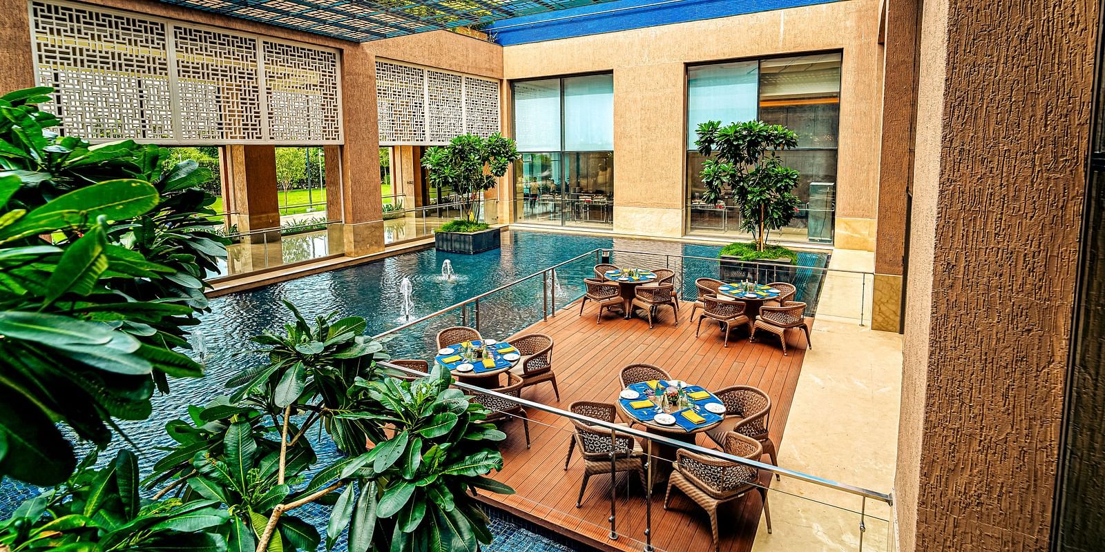A stunning outdoor dining area with water features and natural light, creating a tranquil dining experience