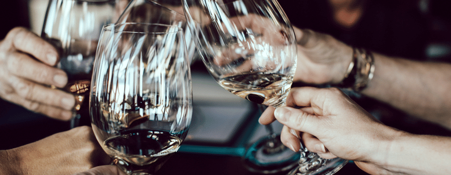 a group of people clinking their wine glasses