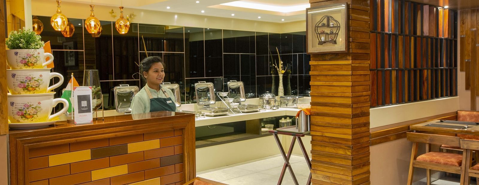 Image of a restaurant staff standing at the Honeycomb Restaurant at Coral Reef Hotel & Spa in Port Blair