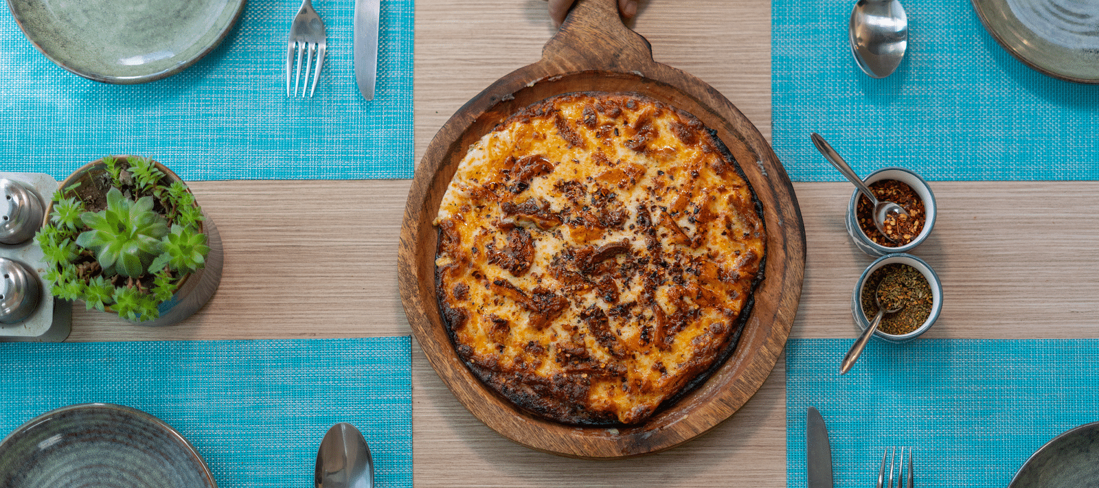 A fresh pizza served hot with toppings at BluSalzz Escapade Resort, Lansdowne.