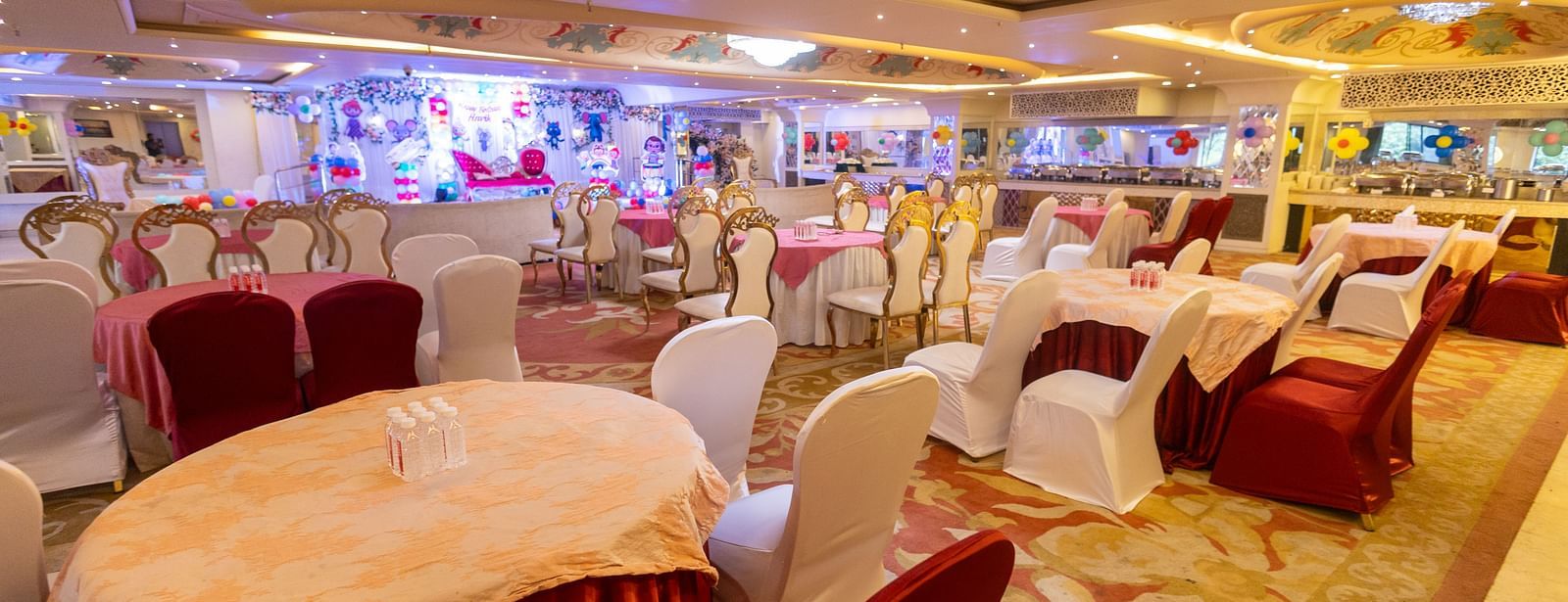 Samrat featuring round tables draped with tablecloths, some in light colours and others in a darker shade.