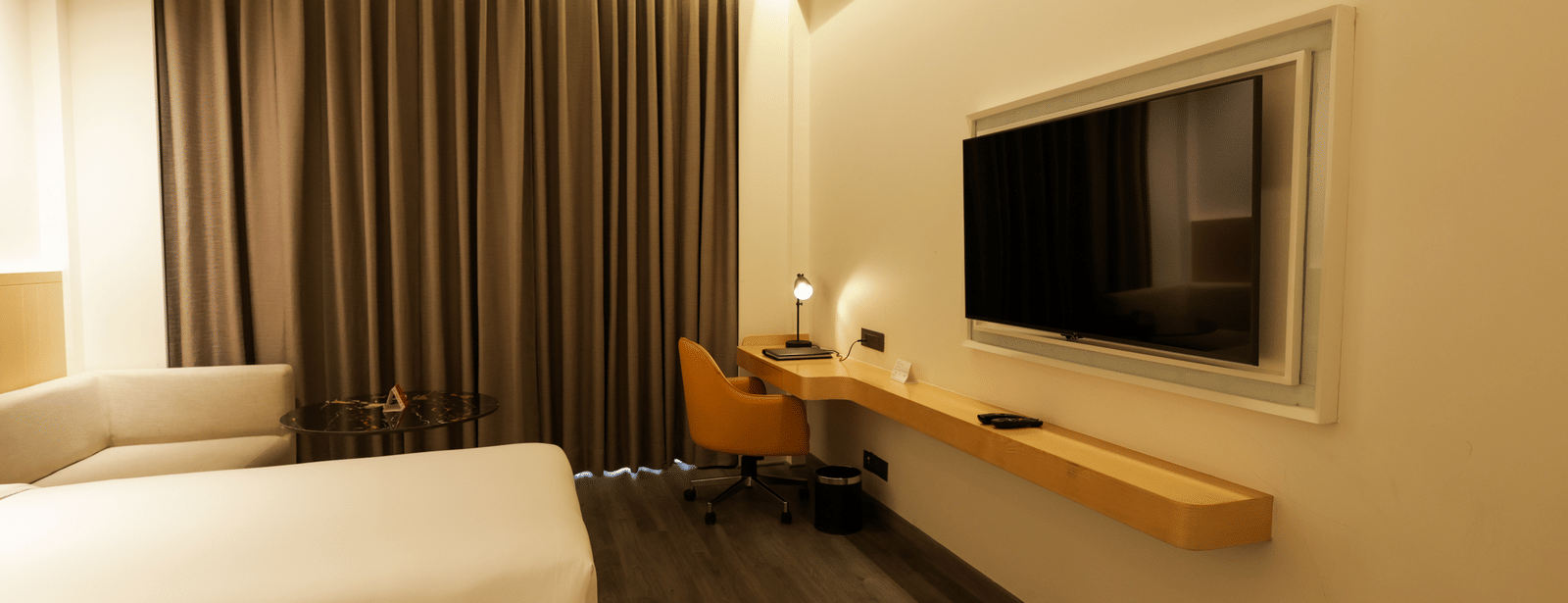 Cosy room with comfortable bed, flat-screen TV, and ambient lighting at Ramada by Wyndham Sonipat Murthal