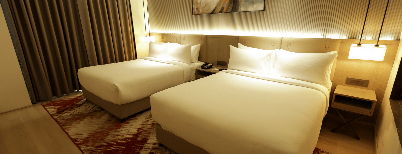 Bedroom with ambient lighting and artwork at Ramada by Wyndham Sonipat Murthal