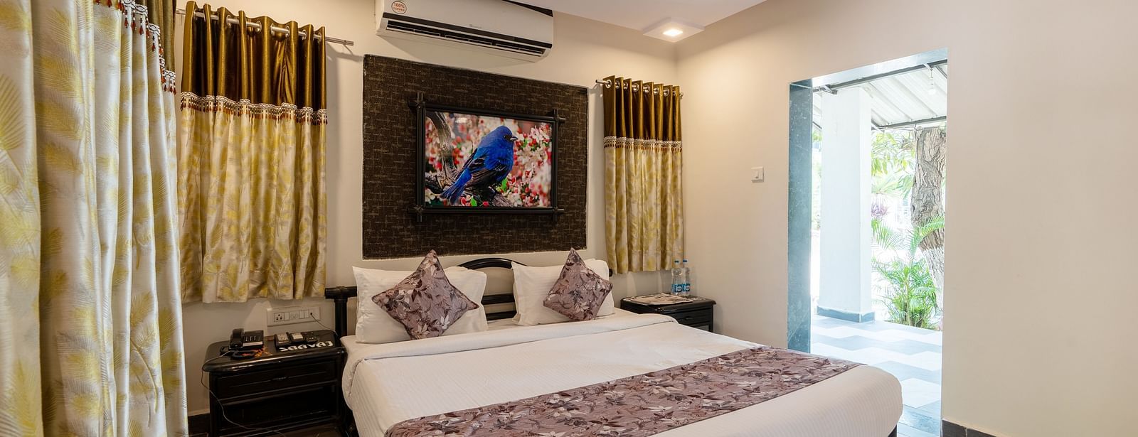A room with with a double bed and side tables at Saavaj Resort