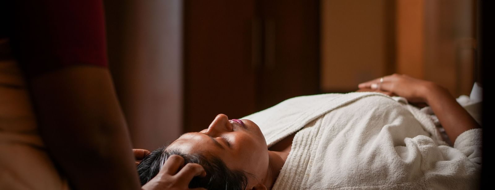 Relaxing head massage in Vedic Village Spa Resort, featuring a person experiencing a therapeutic treatment.