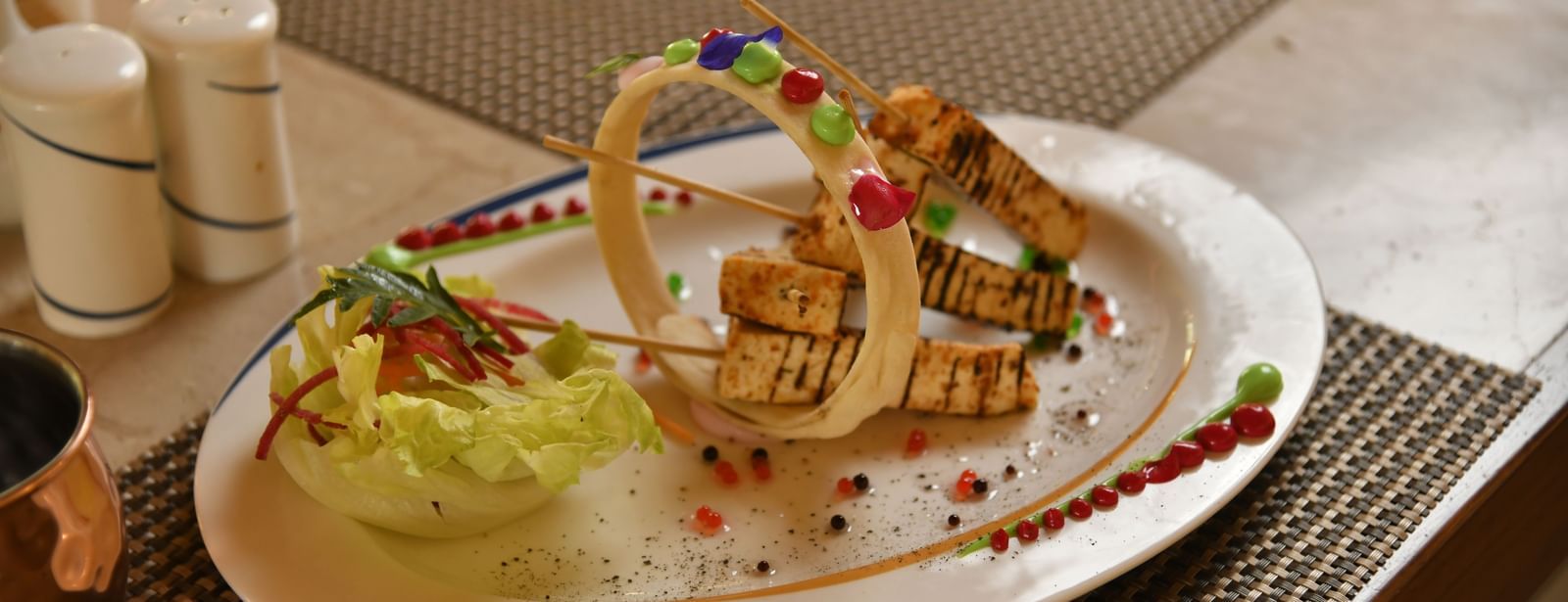 A well set plate of food on a table at Vedic Village Spa Resort.
