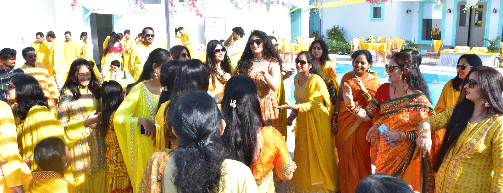 Family and friends enjoying the haldi rituals in a lively setting at Vedikant Resorts The Mallard Corbett.