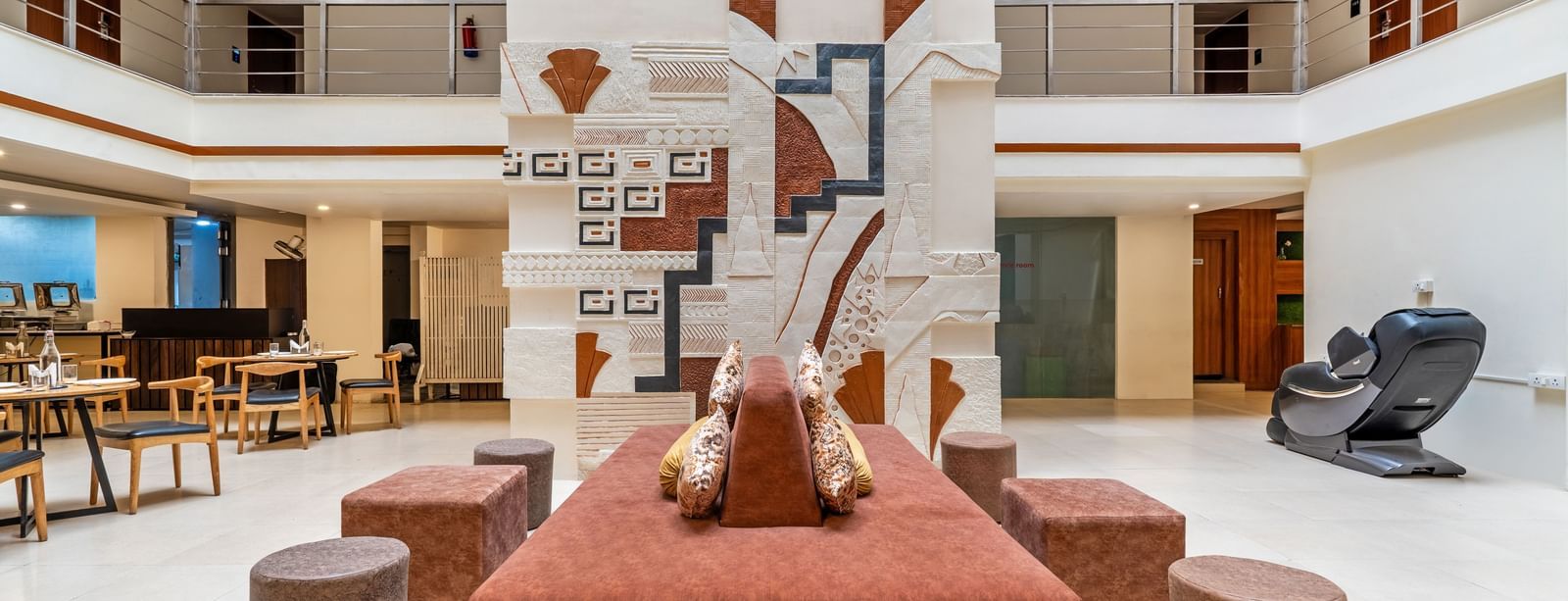 A spacious hotel lobby with seating arrangements and decorative elements - Monday Hotels HITEC City, Hyderabad