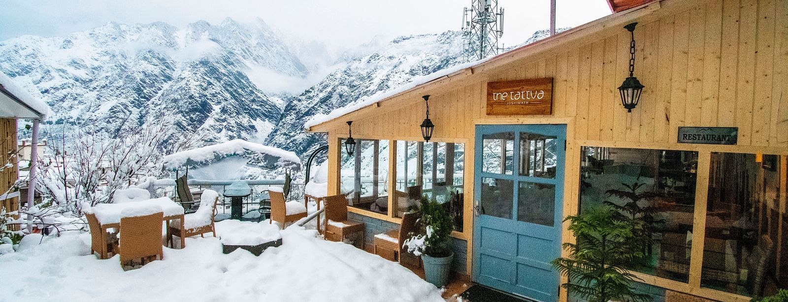 image of the tattva, joshimath featuring the outdoor dining area with a think blanket of white snow