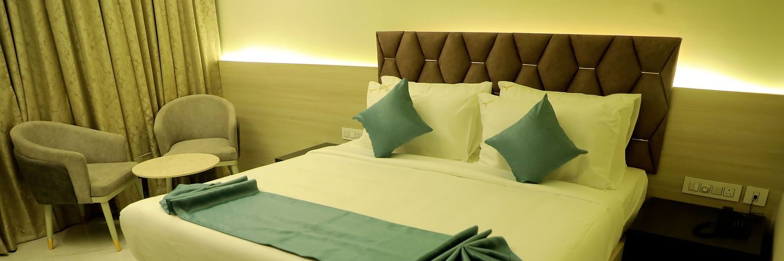 Luxurious king-size bedroom at Town Square Suites with modern decor and ambient lighting