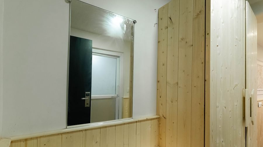 an image of a wooden wardrobe with a mirror at Avianna New Mandala Hotel & Spa, Darjeeling