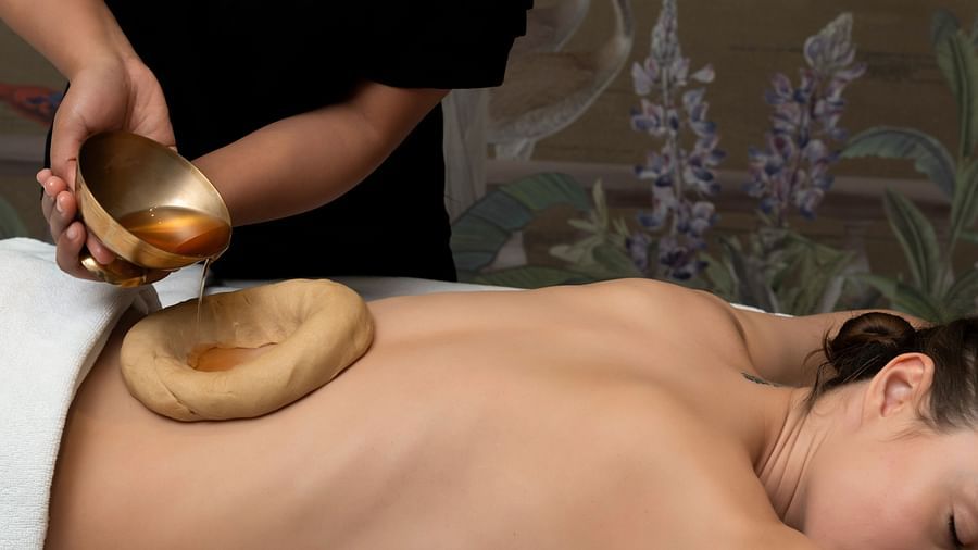 A woman receiving a Pizhichil treatment at Cinqtuair Spa in New Delhi at the Claridges