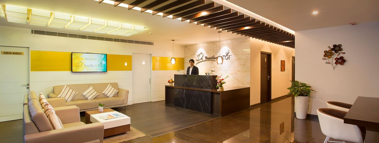 A view of the sleek and spacious lobby of our hotel with contemporary design and a reception area - De Venetian by TGI, Brookefield
