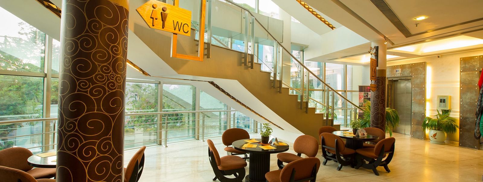 lobby of Hotel Atithi - TGI Grand, Pondicherry arrayed tables and chairs