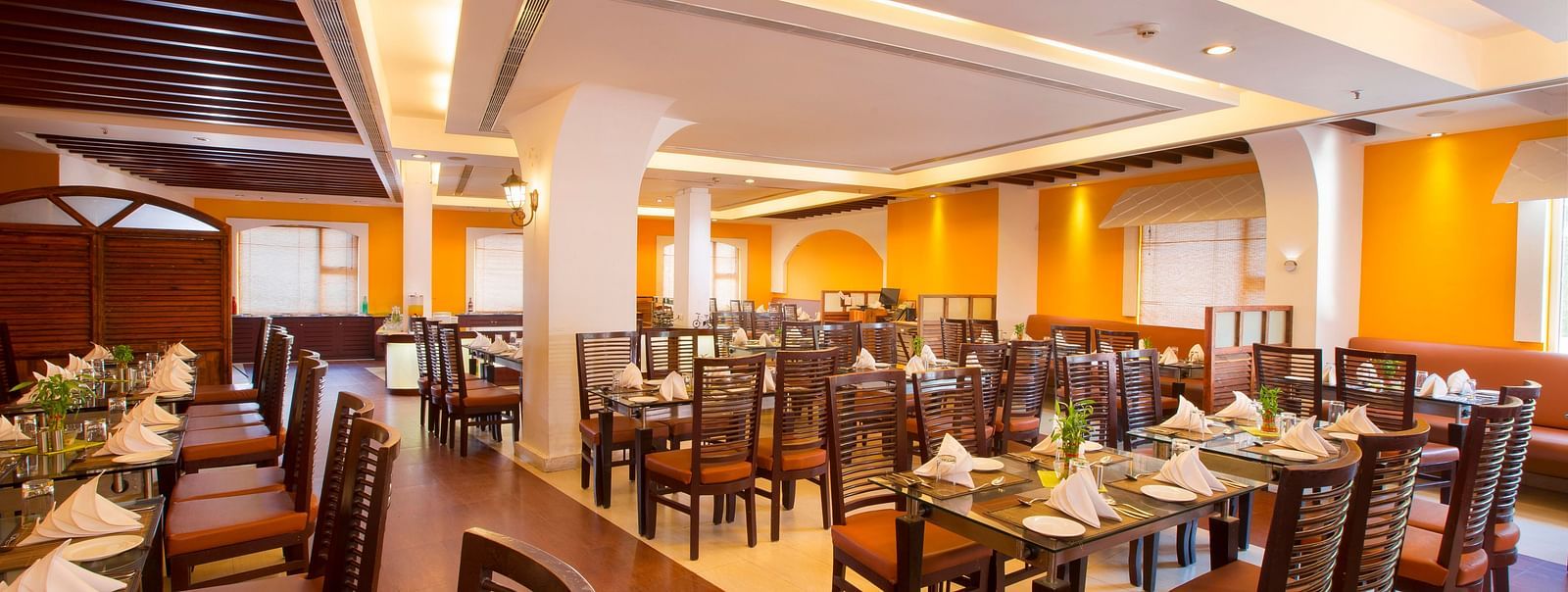 rows of chairs and table placed in a dining table at Hotel Atithi - TGI Grand, Pondicherry